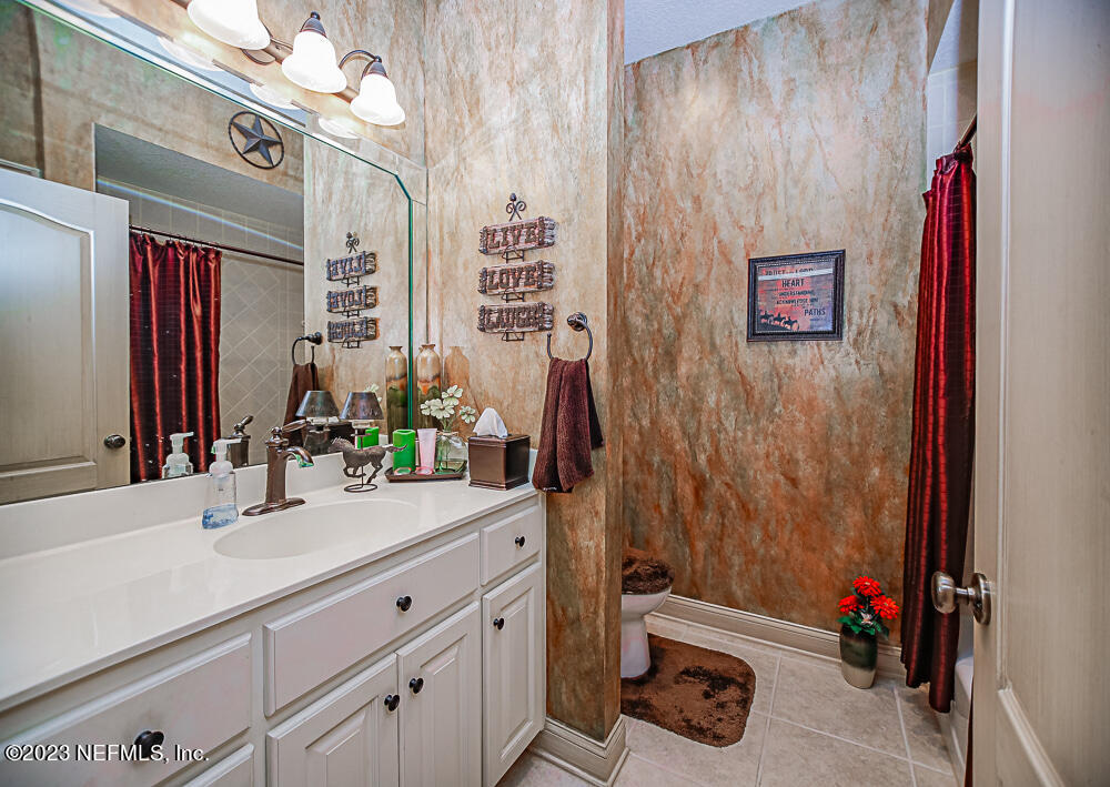 12625 Sawpit Road Jacksonville, FL 32226 - Photo 51 of 63 a bathroom with a sink vanity and a mirror
