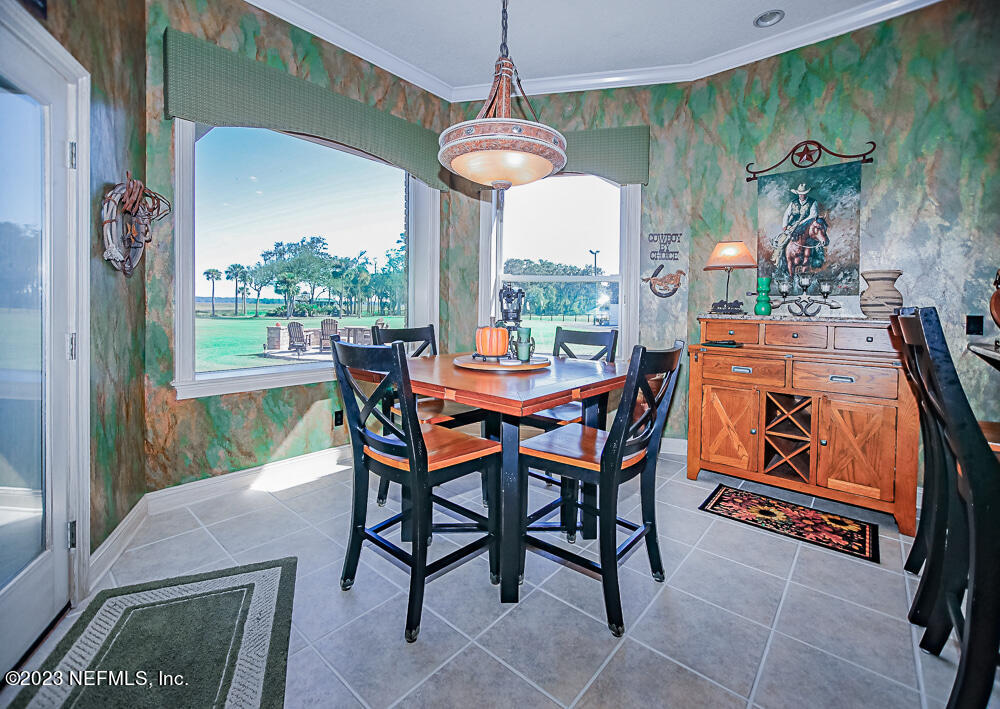 12625 Sawpit Road Jacksonville, FL 32226 - Photo 55 of 63 a dining room with furniture a chandelier and a rug