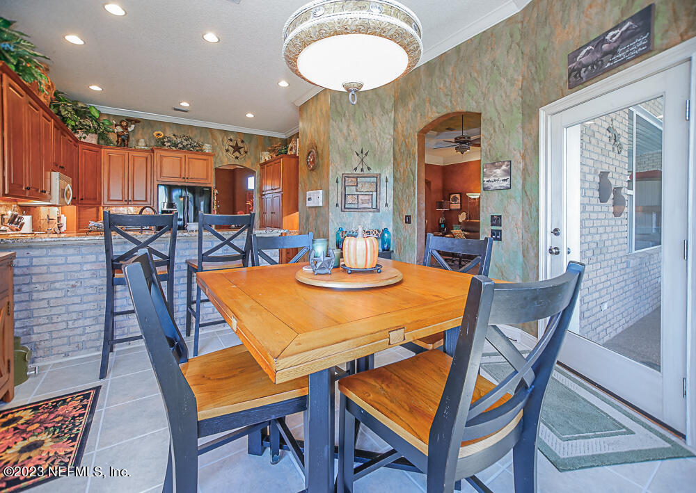 12625 Sawpit Road Jacksonville, FL 32226 - Photo 56 of 63 a dining room with a table and chairs