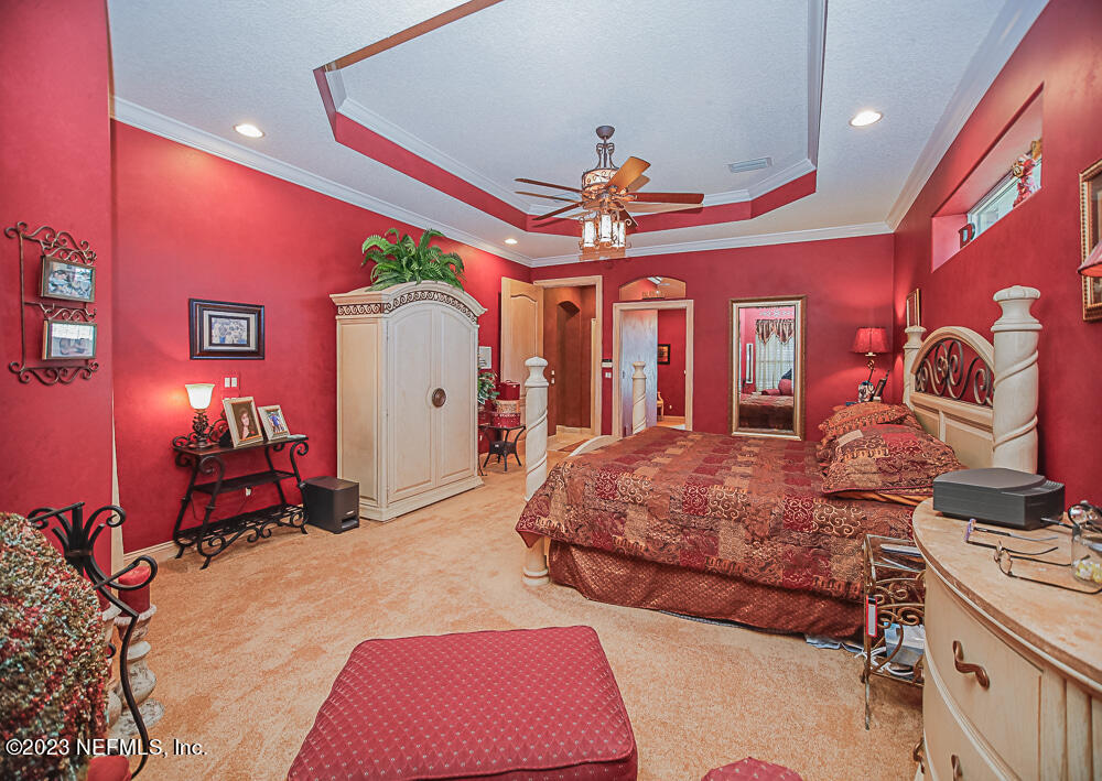 12625 Sawpit Road Jacksonville, FL 32226 - Photo 59 of 63 a bedroom with bed and a chandelier