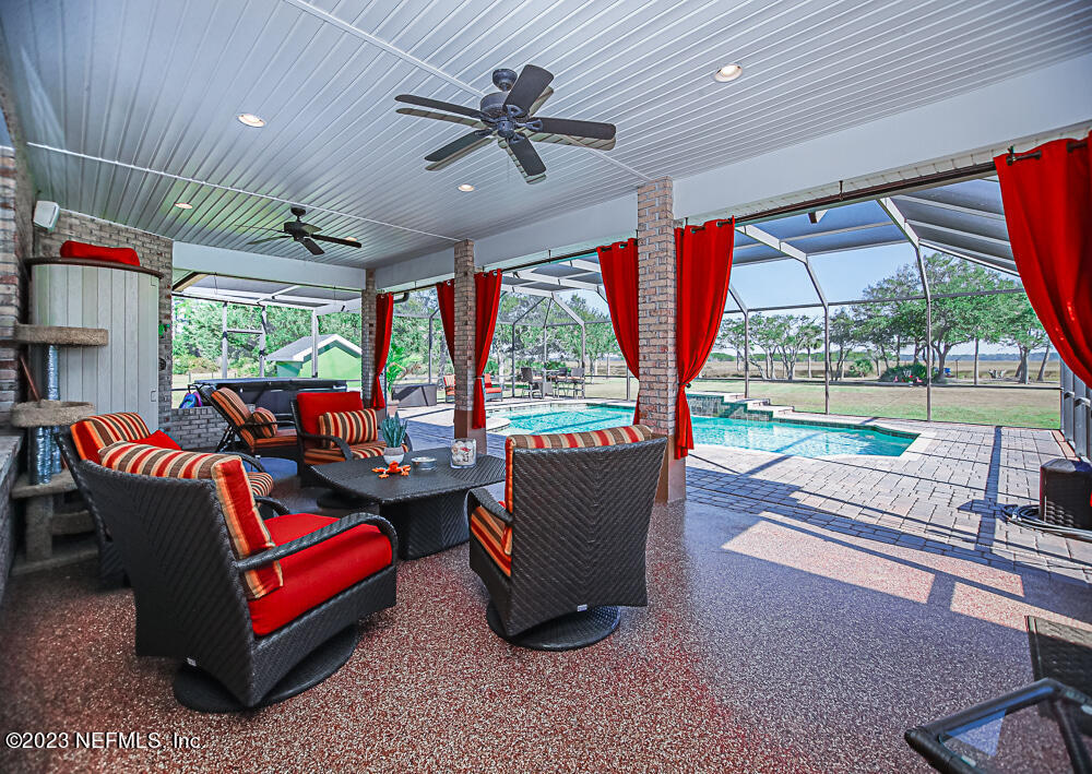 12625 Sawpit Road Jacksonville, FL 32226 - Photo 60 of 63 a living room with furniture and a floor to ceiling window