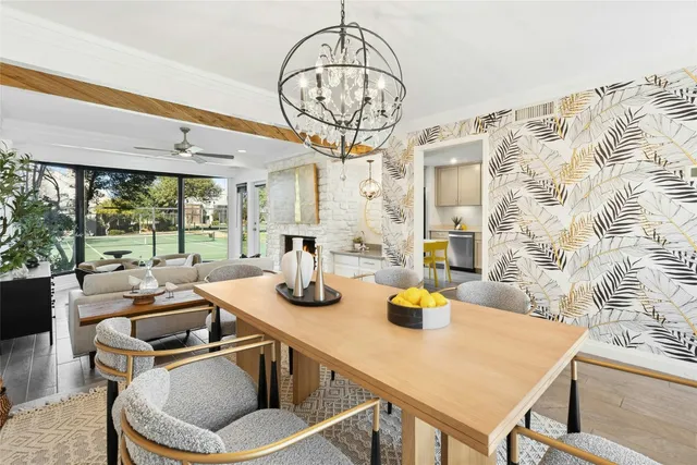 a kitchen with a table chairs and a chandelier