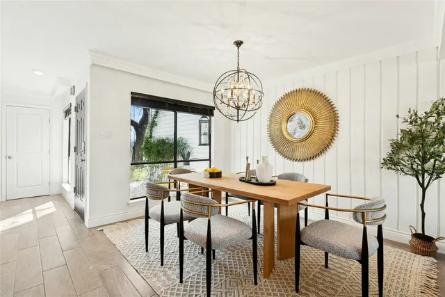 a view of a dining room with furniture window and a chandelier