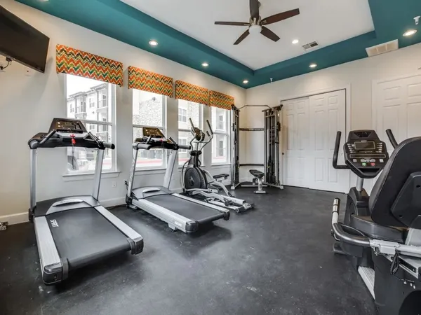 a room with gym equipment and a large window