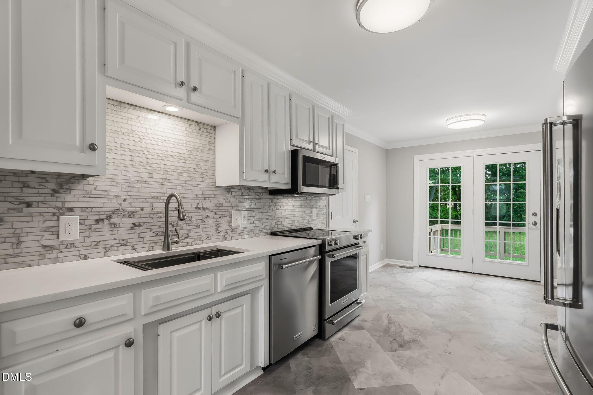 1112 Tyler Farms Drive Raleigh, NC 27603 - Photo 21 of 78 a kitchen with stainless steel appliances granite countertop a sink a stove a microwave and cabinets