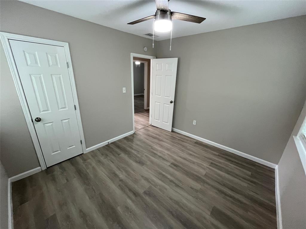 2706 Gross Road Dallas, TX 75228 - Photo 12 of 23 This room features neutral-toned walls, wood-look flooring, and a ceiling fan with an integrated light fixture