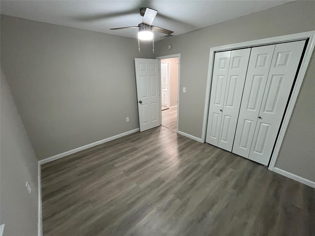 2706 Gross Road Dallas, TX 75228 - Photo 14 of 23 This room features light grey walls, light-colored flooring, a ceiling fan with an integrated light fixture, and a white bi-fold closet