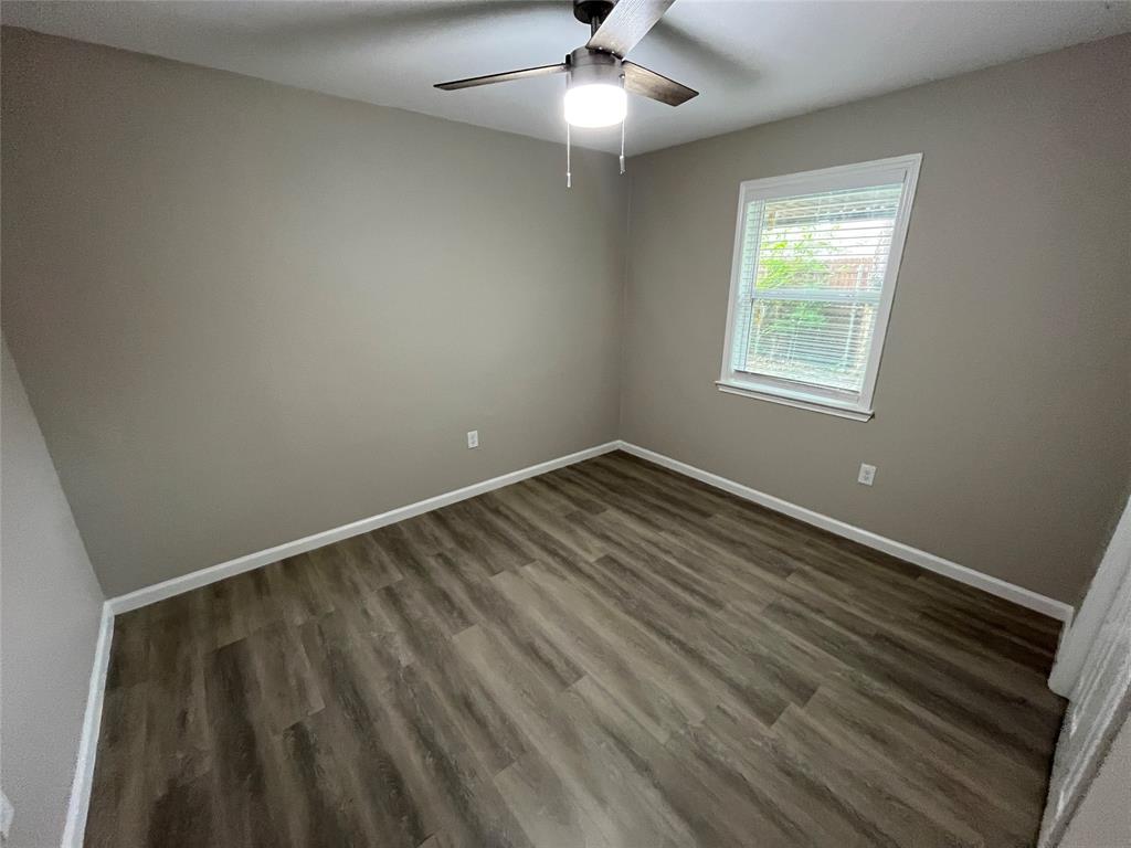 2706 Gross Road Dallas, TX 75228 - Photo 15 of 23 This room features wood-look flooring, a ceiling fan with integrated lighting, and a window fitted with blinds, providing natural light