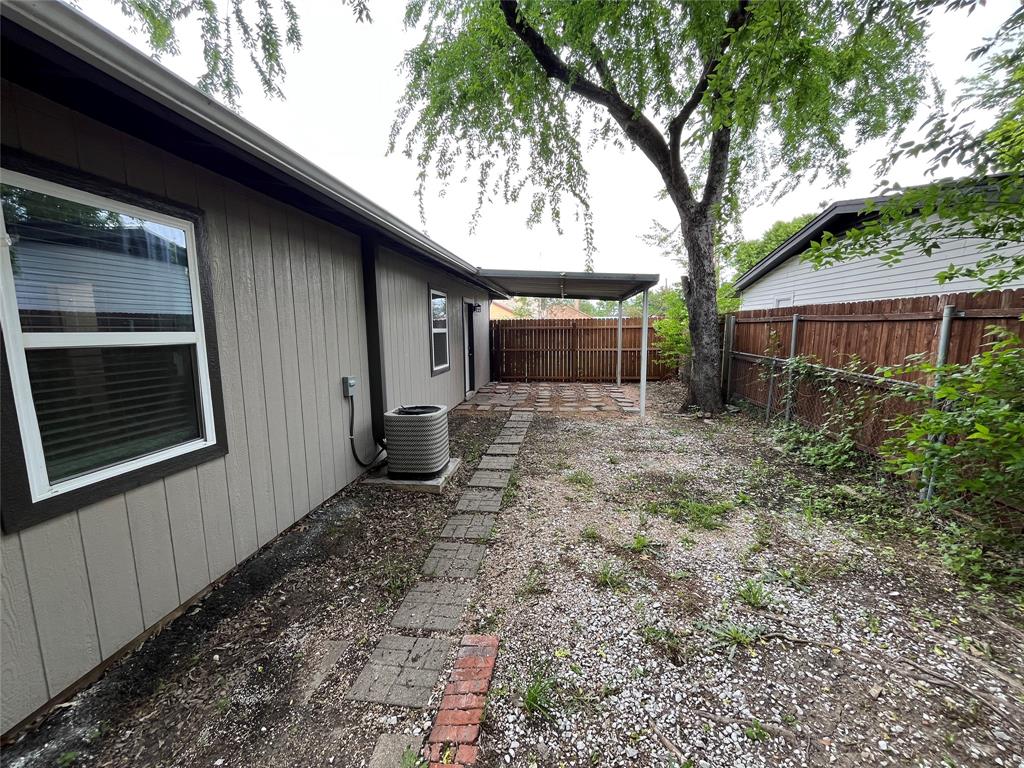 2706 Gross Road Dallas, TX 75228 - Photo 18 of 23 The property features a fenced yard with a large tree and a covered patio area