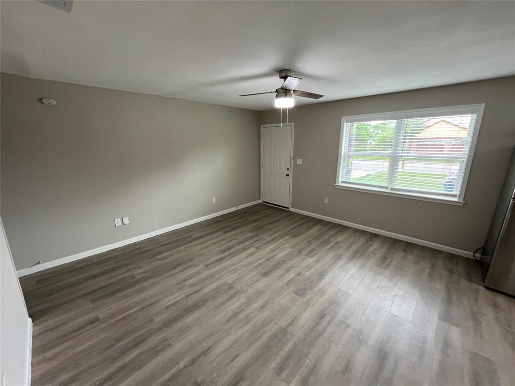 2706 Gross Road Dallas, TX 75228 - Photo 5 of 23 The property features light-toned plank flooring, neutral wall paint, and a window with blinds providing natural light
