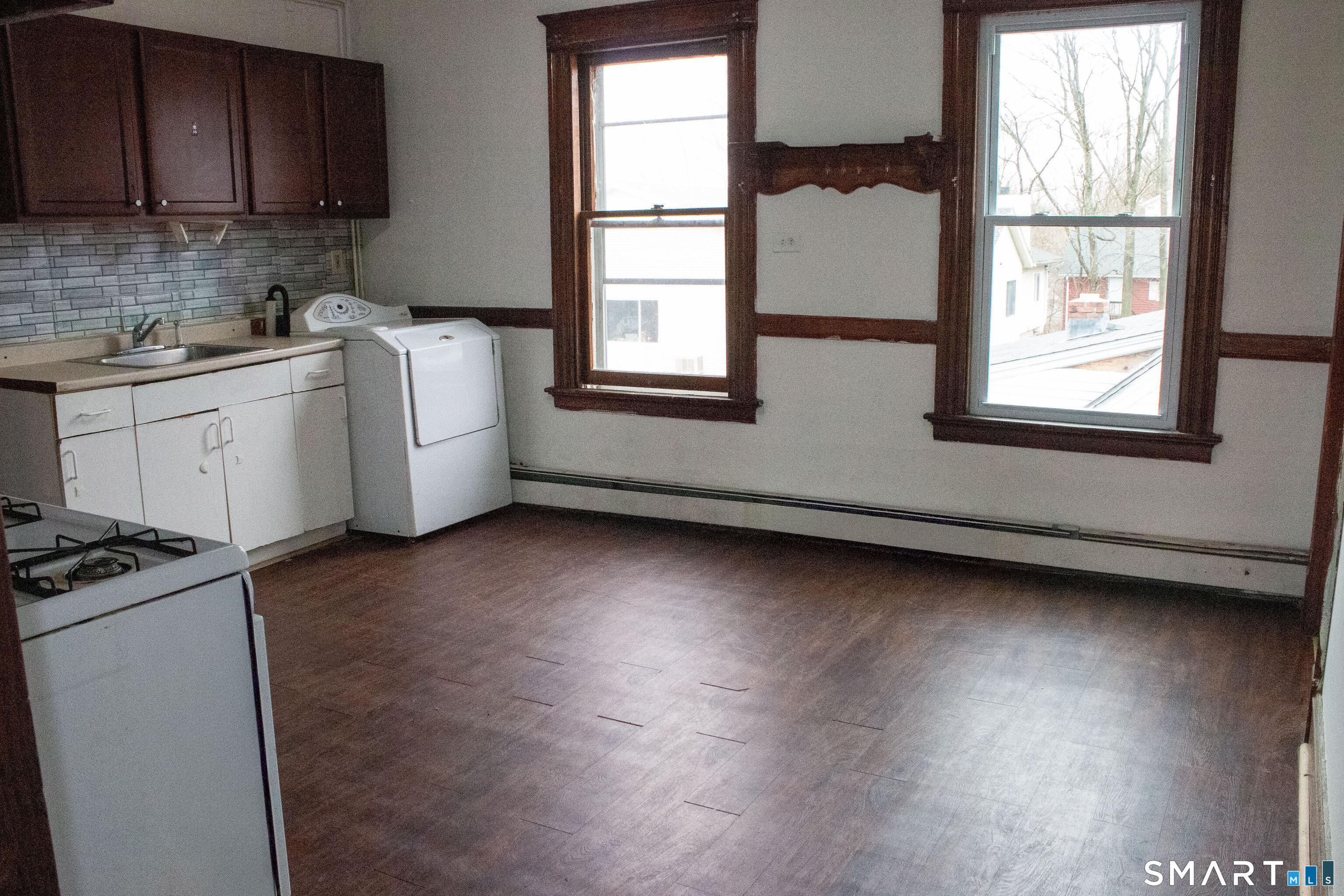 405 Wilson Street, Unit 3 Waterbury, CT 06708 - Photo 4 of 7 a view of a kitchen with sink and dishwasher wooden floor