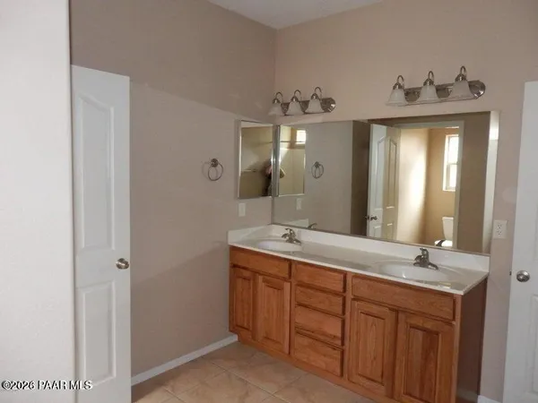 a bathroom with a double vanity sink and a mirror