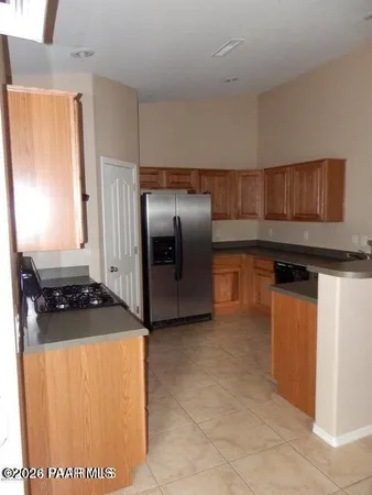 a kitchen with stainless steel appliances granite countertop a refrigerator and a stove