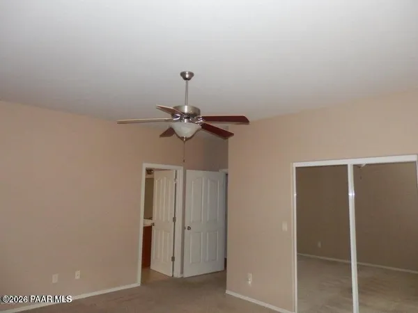 a view of room with a ceiling fan