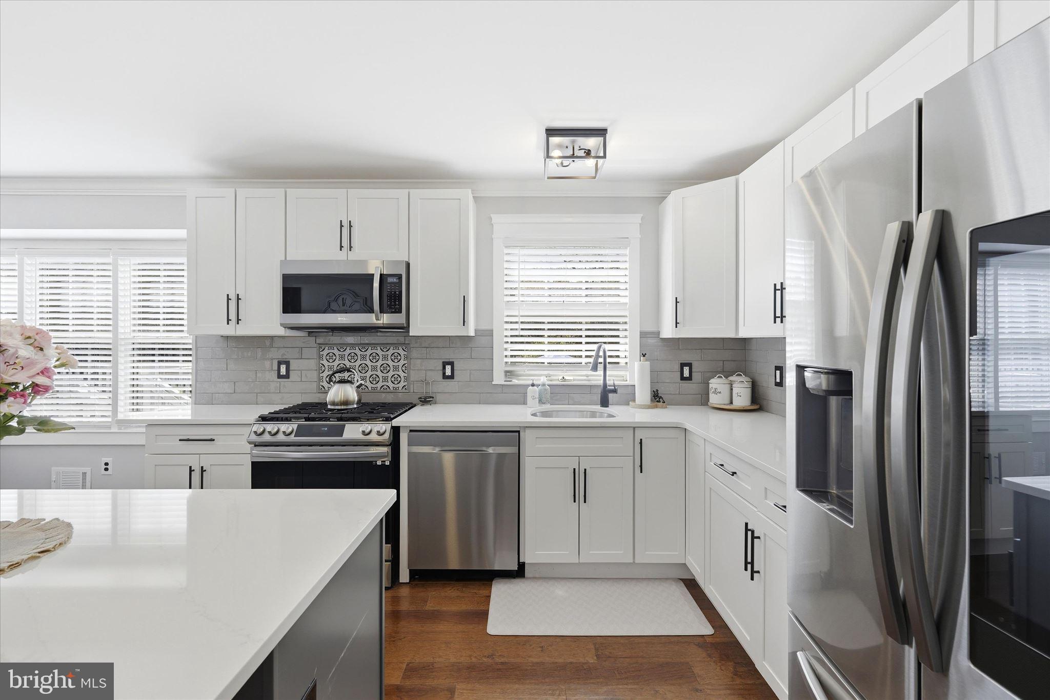 176 Warren Grove Road Barnegat, NJ 08005 - Photo 24 of 71 a kitchen with stainless steel appliances a sink stove refrigerator and a window