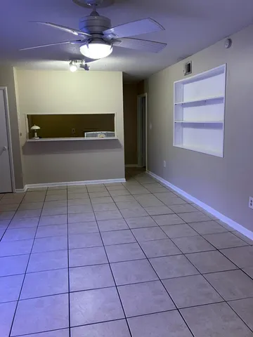 a view of a livingroom with an empty space and a ceiling fan
