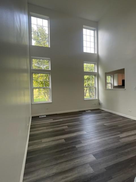 644 Lancaster Drive Pingree Grove, IL 60140 - Photo 9 of 21 an empty room with wooden floor and windows