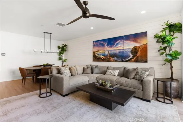 a living room with furniture and a potted plant