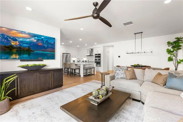 a living room with stainless steel appliances kitchen island granite countertop furniture and a kitchen view