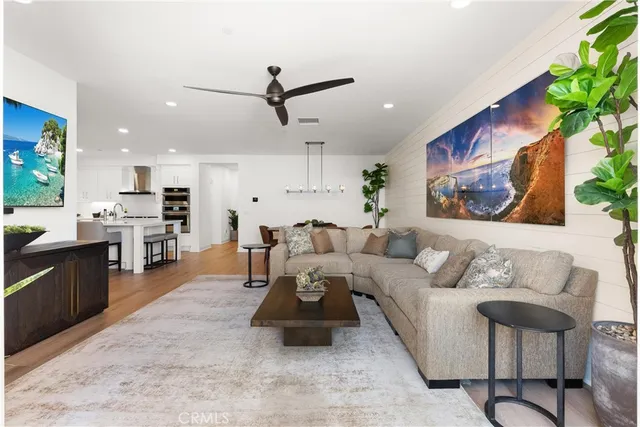 a living room with furniture and kitchen view