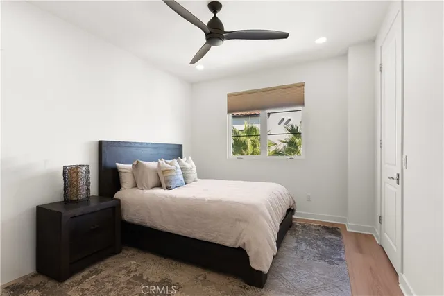 a bedroom with a bed and painting on the wall