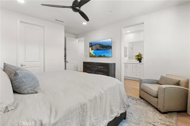 a bedroom with a bed couch and window