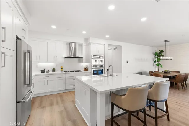 a large kitchen with a table and chairs