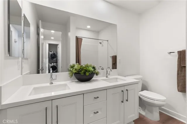a bathroom with double sink and a mirror