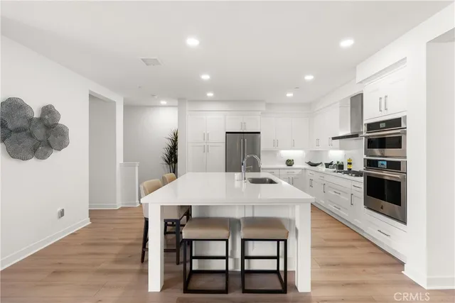 a large kitchen with a table and chairs