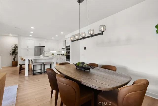 a dining room with furniture and wooden floor