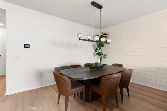 a dining room with furniture and wooden floor
