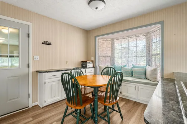 a dining room with furniture and wooden floor