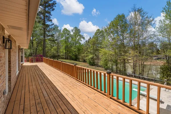a view of balcony with wooden floor and fence