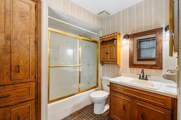 a bathroom with a sink toilet and shower
