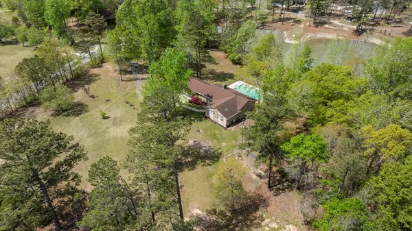 a aerial view of residential houses with outdoor space and trees