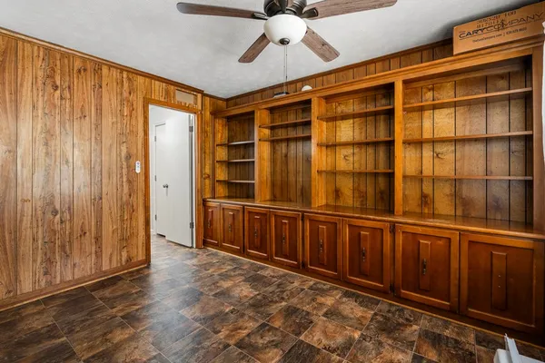 a view of a closet area with wooden floor