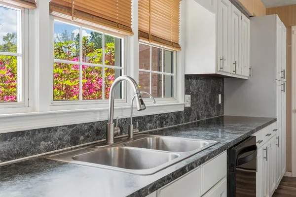 a kitchen with granite countertop a sink and a window