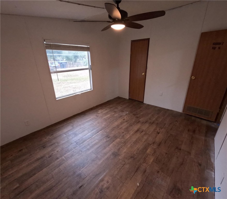 590 Lee Street Victoria, TX 77905 - Photo 13 of 41 an empty room with wooden floor closet and windows