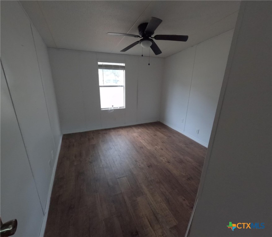 590 Lee Street Victoria, TX 77905 - Photo 16 of 41 an empty room with wooden floor fan and windows