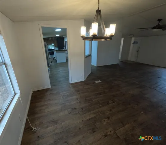 a view of a room with an empty space and a hallway