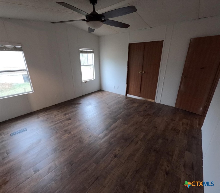 590 Lee Street Victoria, TX 77905 - Photo 34 of 41 an empty room with wooden floor and windows