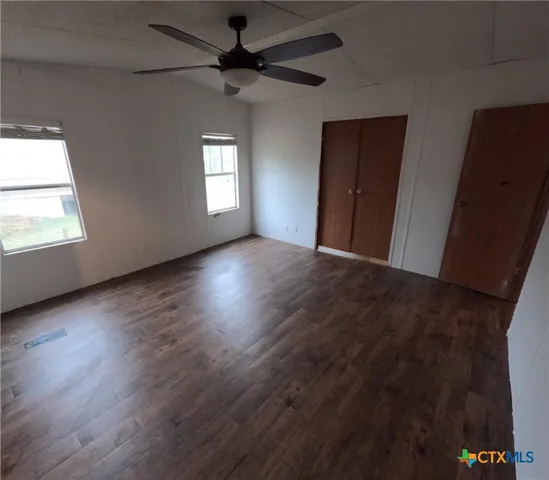 a spacious bathroom with a tub sink and mirror