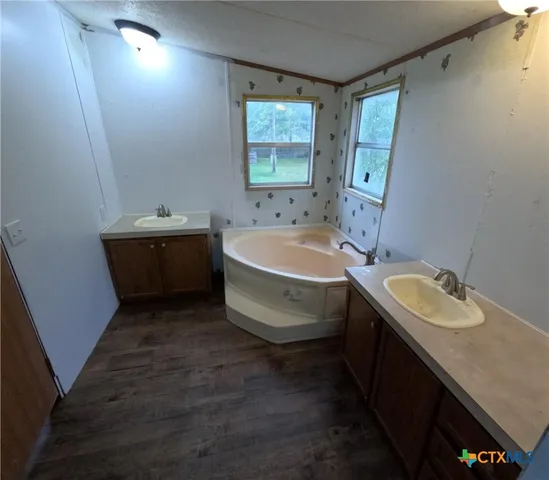 a bathroom with a double vanity sink and mirror