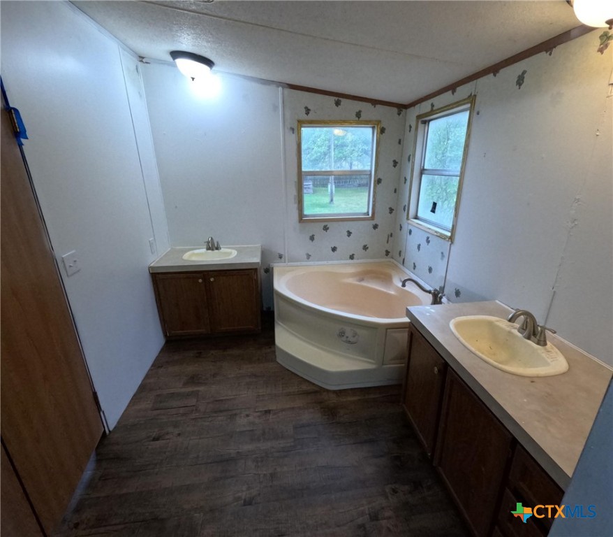 590 Lee Street Victoria, TX 77905 - Photo 37 of 41 a bathroom with a double vanity sink and mirror