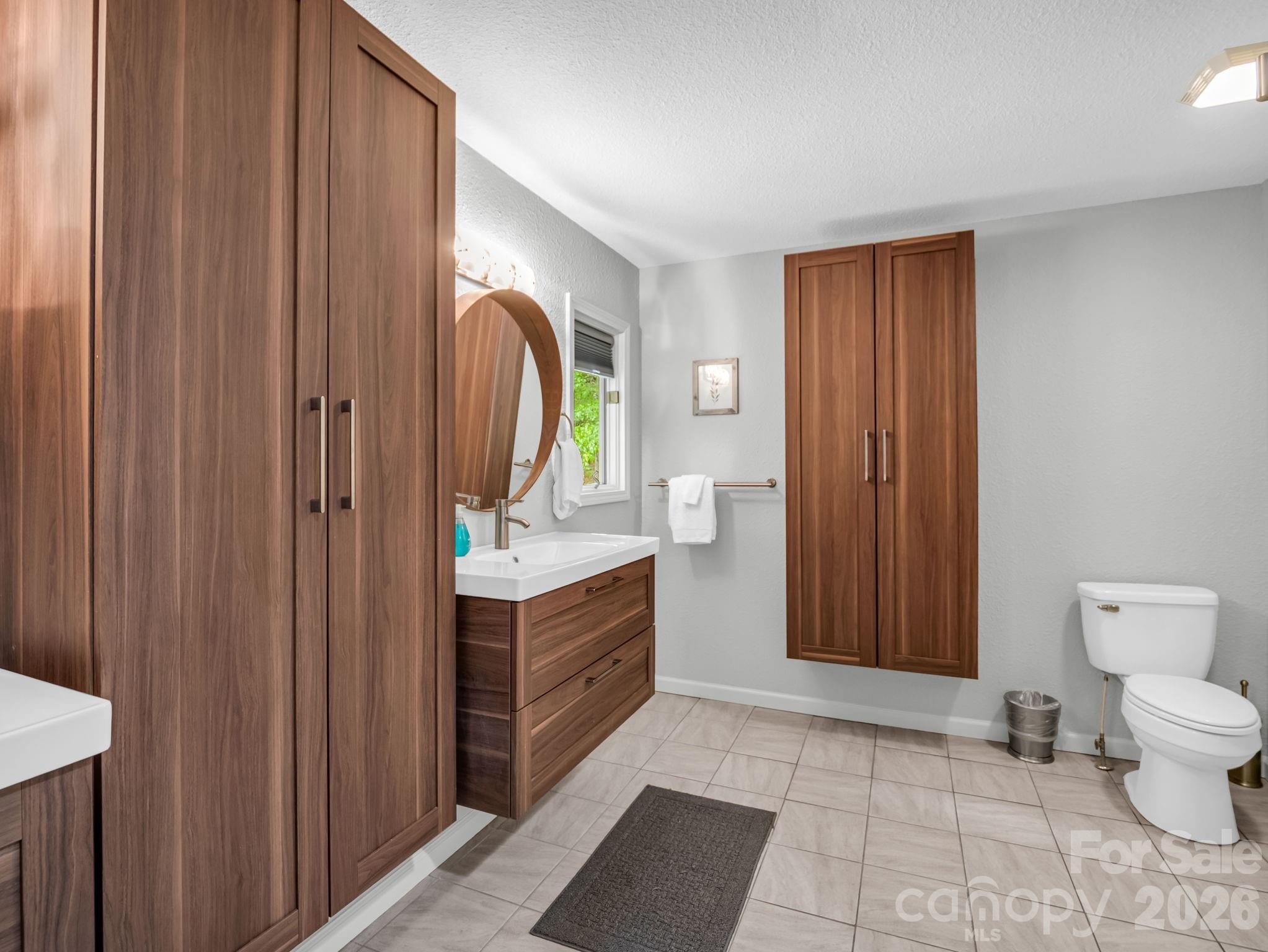 656 Cashiers Valley Road Brevard, NC 28712 - Photo 17 of 37 a spacious bathroom with a mirror and a toilet