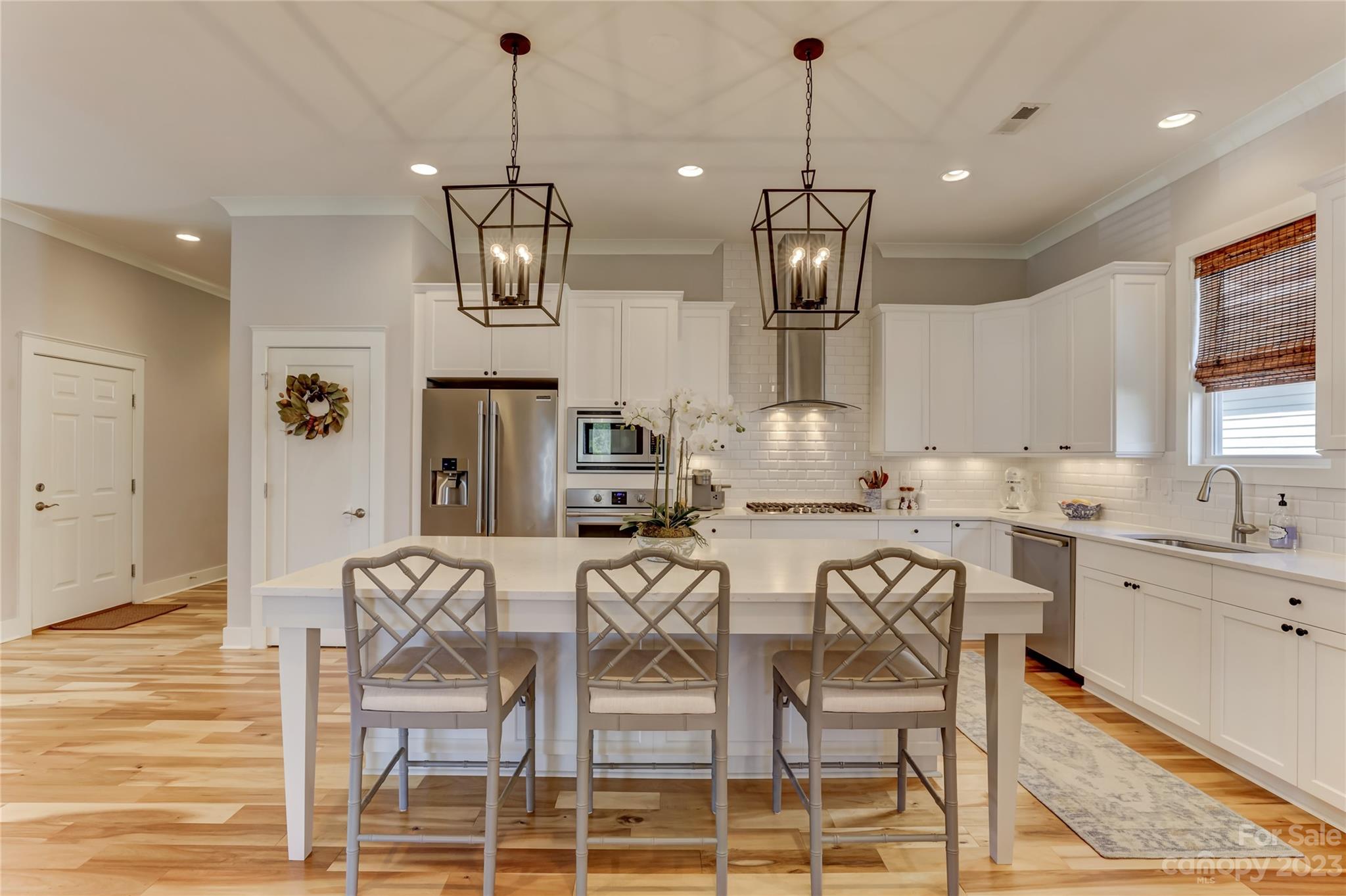 151 Inspired Way Fort Mill, SC 29708 - Photo 13 of 48 a very nice looking kitchen with granite countertop lots of wooden cabinets a dining table and chairs