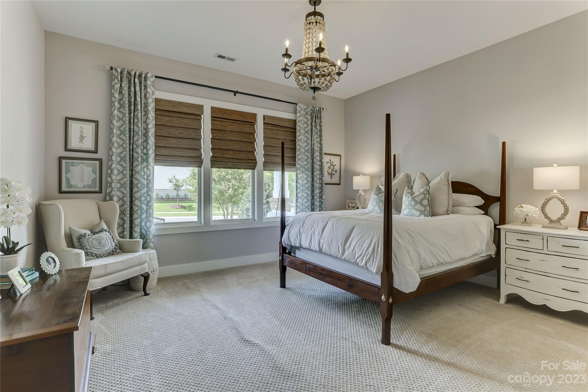 151 Inspired Way Fort Mill, SC 29708 - Photo 30 of 48 a spacious bedroom with a bed and a chandelier