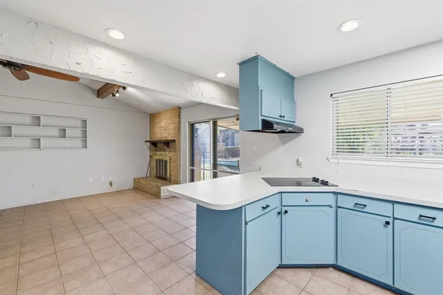 a kitchen with a sink cabinets and window