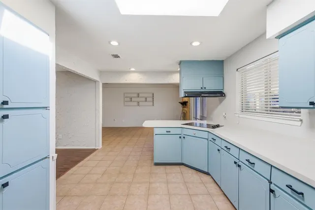 a kitchen with a sink stove and cabinets