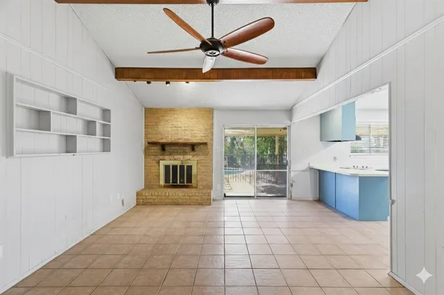 a view of an empty room with a kitchen